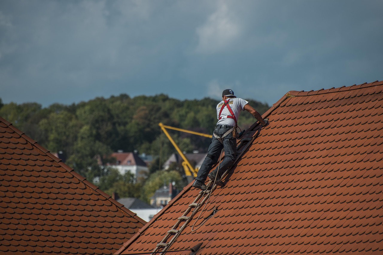 Roofing professional inspecting a residential roof.